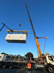 Modular home section being lifted into position by crane during installation · Master Modular Homes & Granny Flat